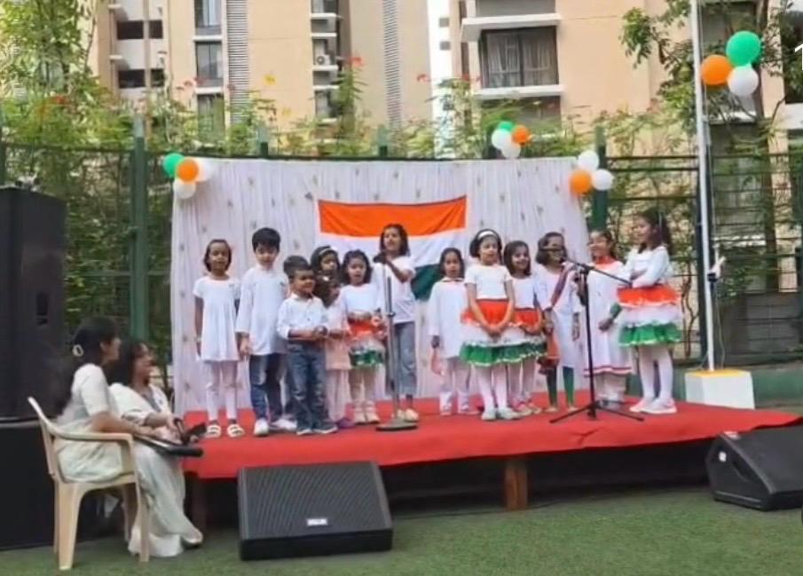 Students performing patriotic songs on stage